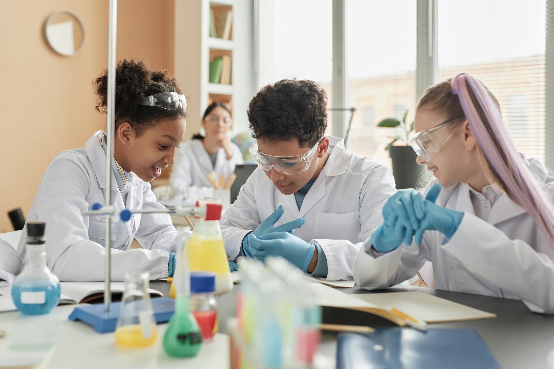 Group of schoolchildren enjoying science experiments in class